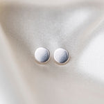 Coin Sterling Silver Earrings on Silk Background