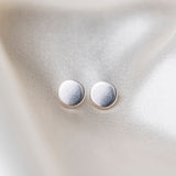 Coin Sterling Silver Earrings on Silk Background