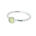 Peridot Gemstone Hammered Texture band, Sterling Silver Ring on a white background