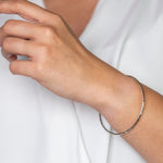 Handmade Hammered Sterling Silver Bangle worn on models wrist