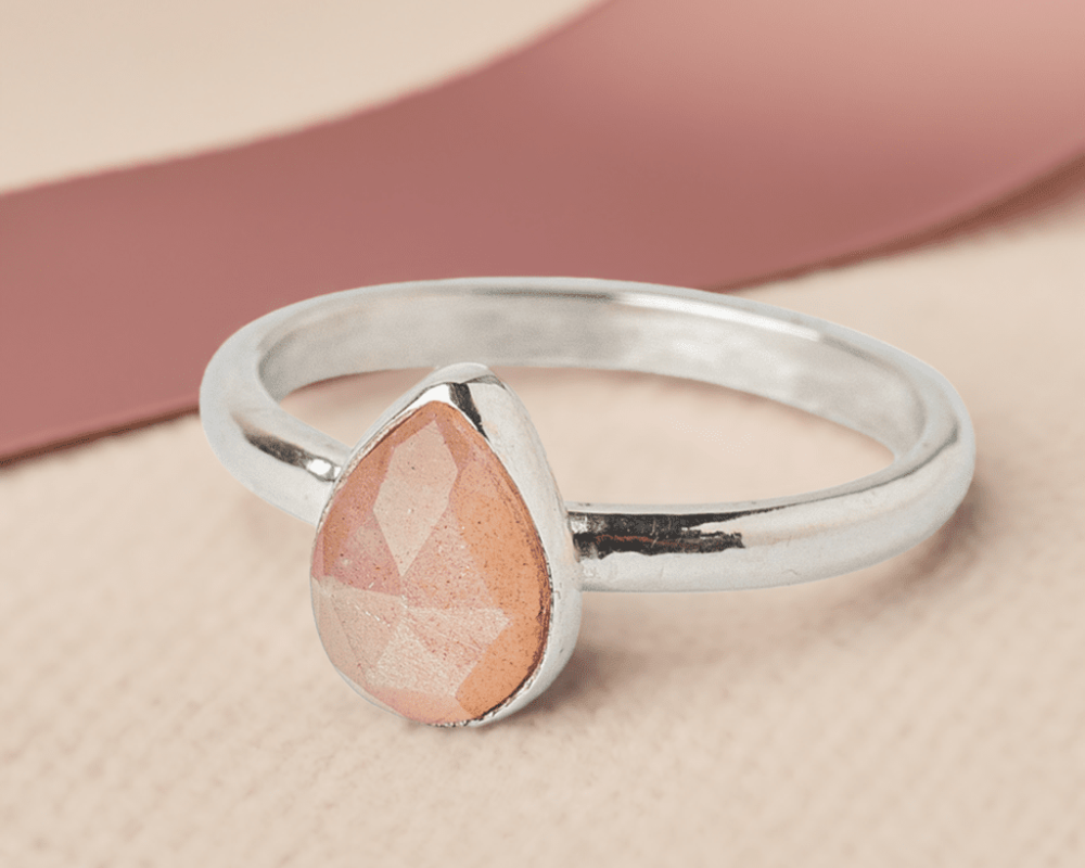 Handmade Sterling Silver Peach Moonstone Pear Gemstone Ring with a pink ribbon.