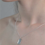 Sterling Silver Tag Pendent Necklace worn by model.