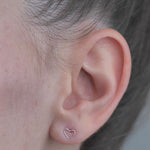 Sterling Silver Mini shaped Heart Earrings worn in models ear.