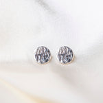Round Hammered Earrings on silk background