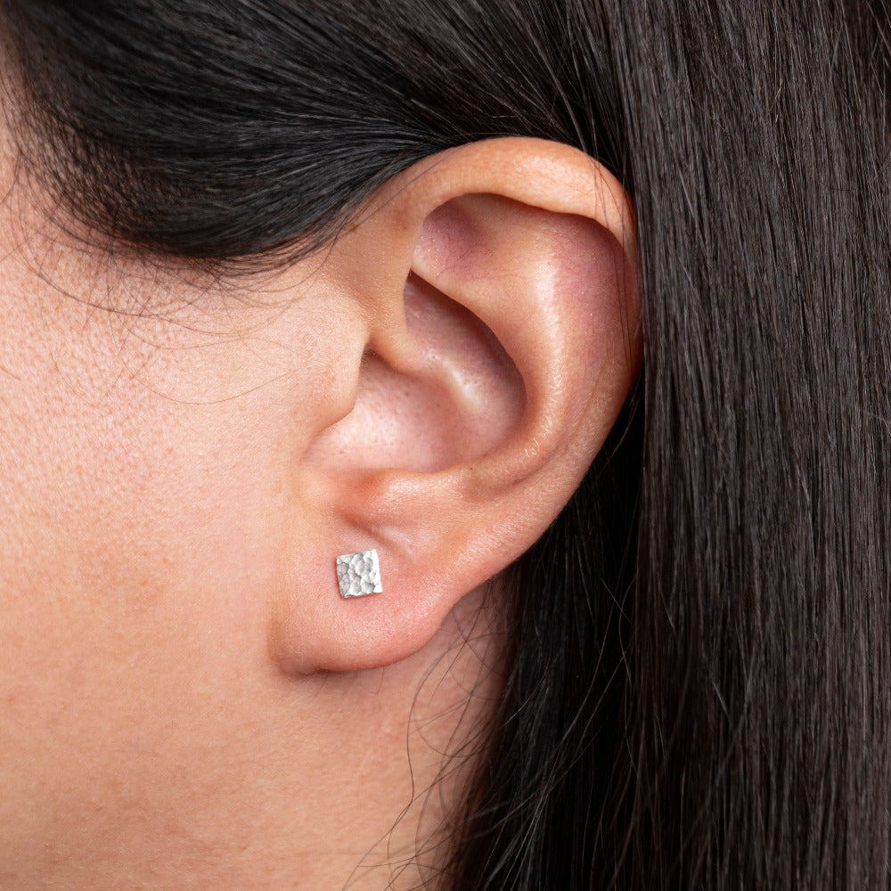 Handmade Sterling Silver Square shaped Hammered textured Earrings worn on models ear lobe