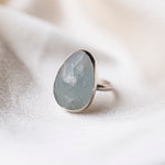 Aquamarine Gemstone SterlingSilver Ring on silk background