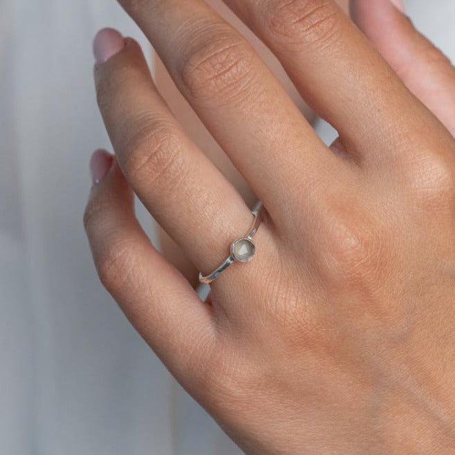 Model wears Grey Moonstone Hammered Sterling Silver Stacking Ring , with a white blouse and frenchtip manicured nails.