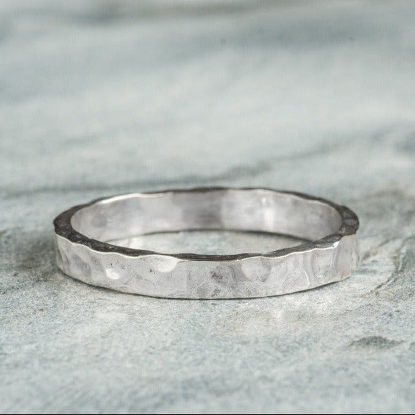 Sterling Silver Hammered textured Ring worn on grey background