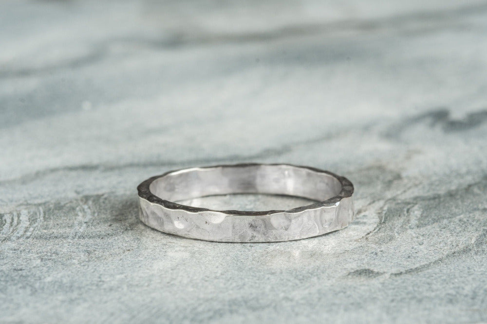 Sterling Silver Hammered textured Ring worn on grey background