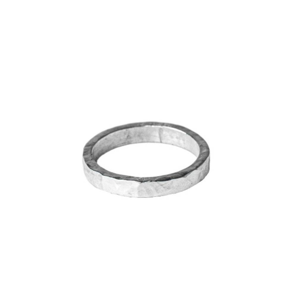 Sterling Silver Hammered textured Ring worn on white background