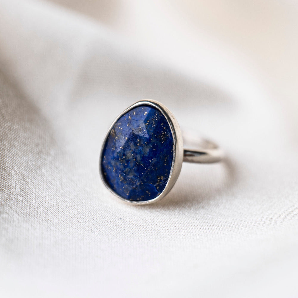 Lapis Gemstone Statement Sterling Silver Ring on silk background 