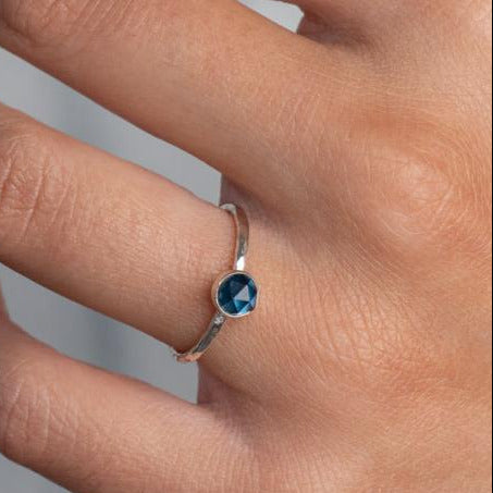 Model wears London Bliue Topaz Hammered Sterling Silver Ring , with a white blouse and frenchtip manicured nails.