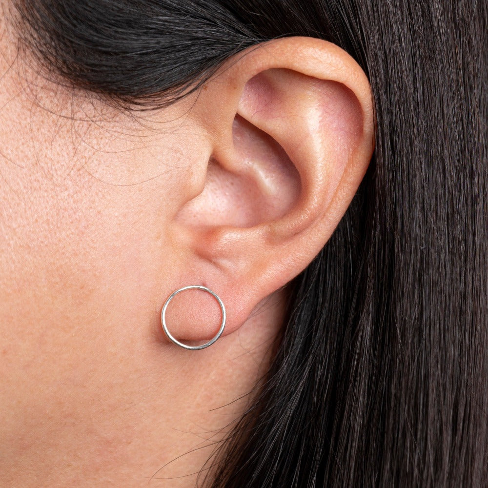 Mini Lunar Earrings model wears on ear lobe