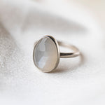 Moonstone Gemstone Sterling Silver Ring worn on silk background