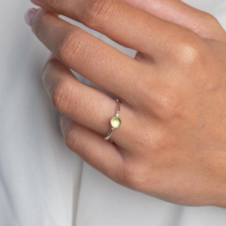 Model wears PeridotHammered Sterling Silver Ring , with a white blouse and frenchtip manicured nails.
