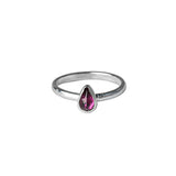 Rhodolite Garnet Gemstone Pear shaped Sterloing Silver Ring worn on white backgrpound 