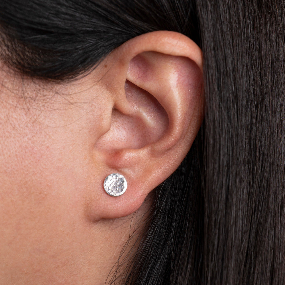 Sterrling Silvrer Round shaped Hammered Textured Earrings worn on models ear lobe
