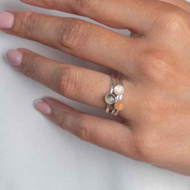 Model wears Moonstone Trio Hammered Sterling Silver Stacking Ring , with a white blouse and frenchtip manicured nails.
