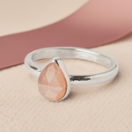 Handmade Sterling Silver Peach Moonstone Pear Gemstone Ring with a pink ribbon.