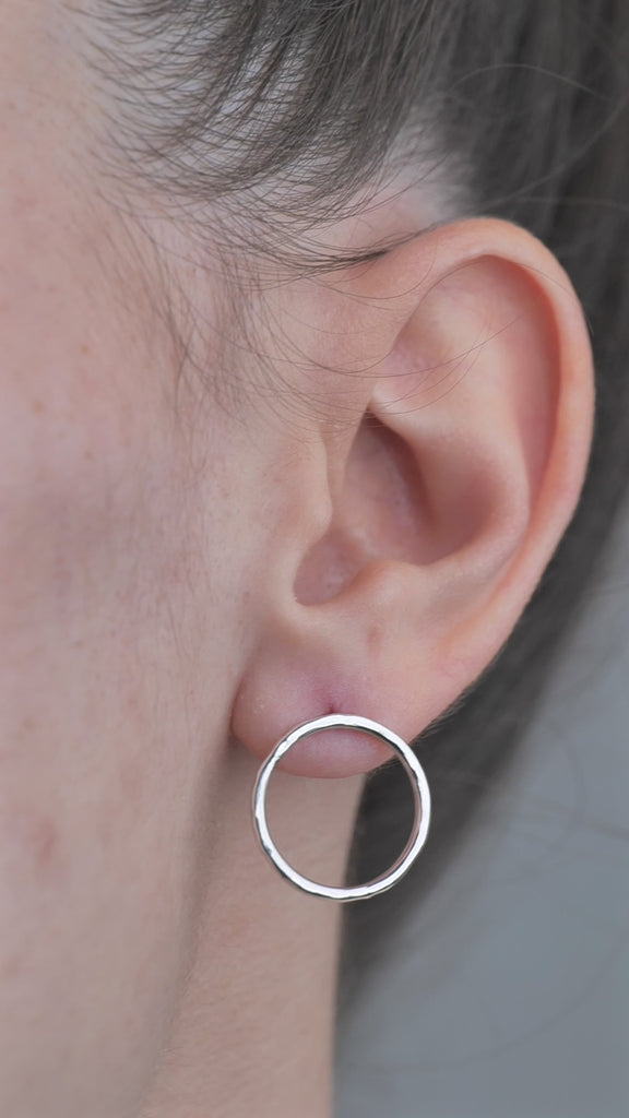 Sterling Silver open circle hammered textured Earrings worn by model in ear. 