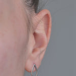 Sterling Silver Earrings Pear shaped, worn in models ear 