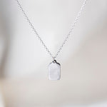 Tag Sterling Silver Necklace on Silk Background 