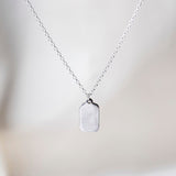Tag Sterling Silver Necklace on Silk Background 